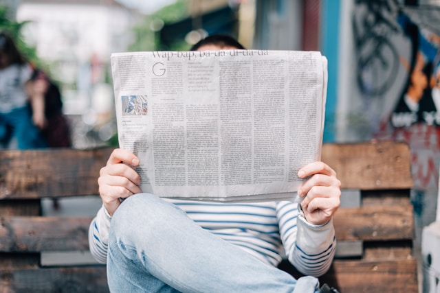 someone is reading a newspaper